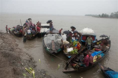 Several Boats With People Standing On Them In The Water