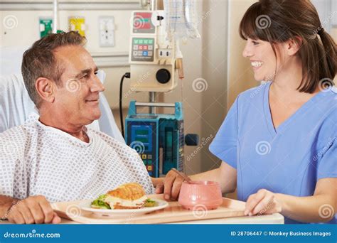 Patient Being Served Meal In Hospital Bed By Nurse Stock Image Image