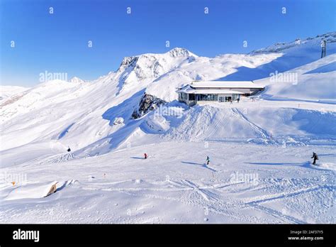 Men Skiers And Snowboarders Cable Car Station On Hintertux Glacier