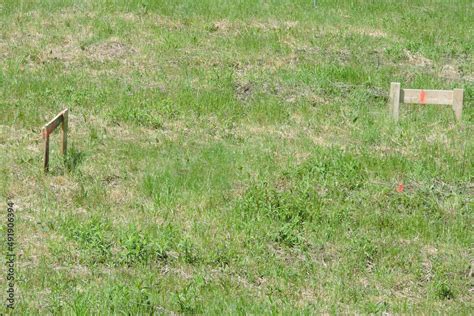 A Wooden Stake And Two Batter Boards Used For Marking Corners Of A New