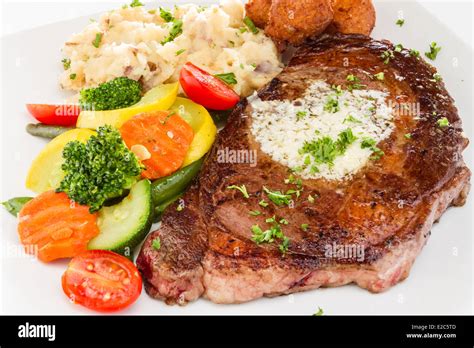 Ribeye Steak Served With Mashed Potatoes Vegetable Medley And Hush