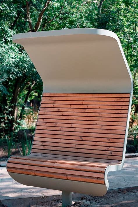 A Wooden Bench Sitting In The Middle Of A Park