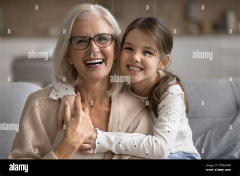 Happy Pretty Tween Granddaughter Girl Hugging Loving Grandma From