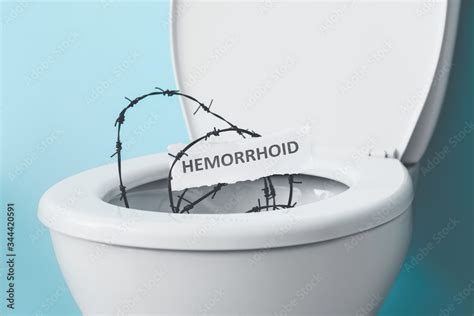 Toilet Bowl With Barbed Wire On Color Background Hemorrhoids Concept