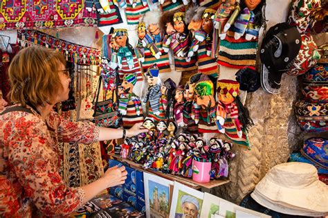 Premium Photo | A tourist chooses uzbek souvenirs in a souvenir shop ...