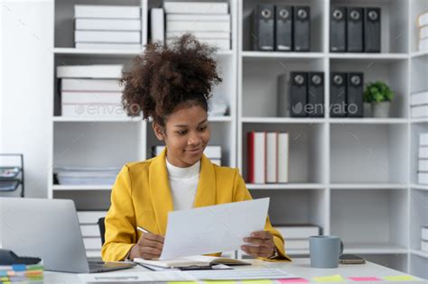 Confident African American Businesswoman Working On Documents Graphs