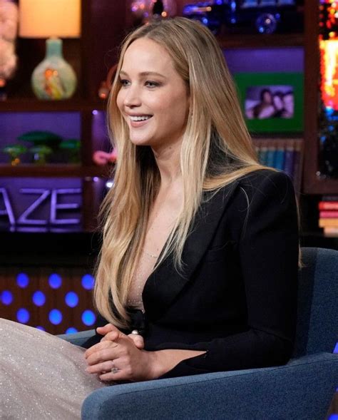 A Woman Sitting In A Blue Chair On The Set Of Tv Shows Tonight Show