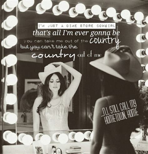 A Woman Standing In Front Of A Mirror With A Cowboy Hat On Top Of Her Head