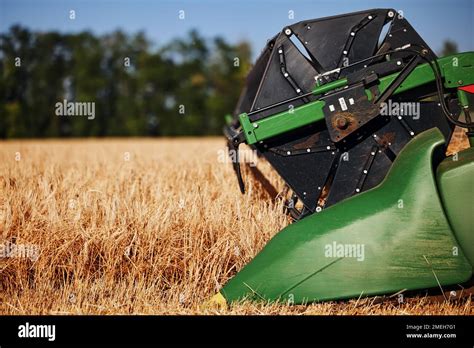 Agricultural Combine John Deere Harvester In The Field During Harvest