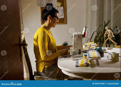 Woman Sewing On A Sewing Machine At Her Home Stock Photo Image Of