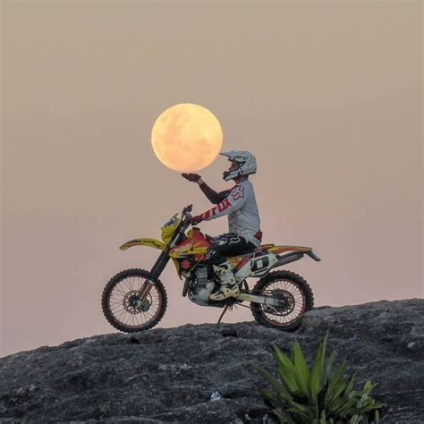 A Person On A Dirt Bike With The Moon In The Background