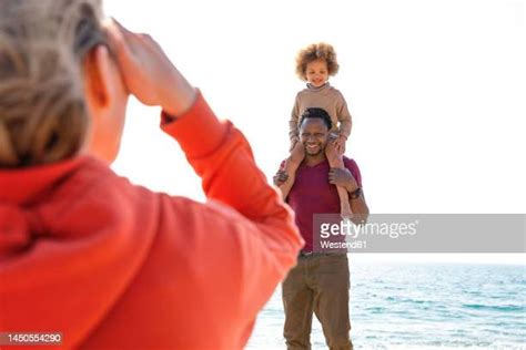 27 Black Father Carrying Daughter On Shoulders At Beach Stock Photos