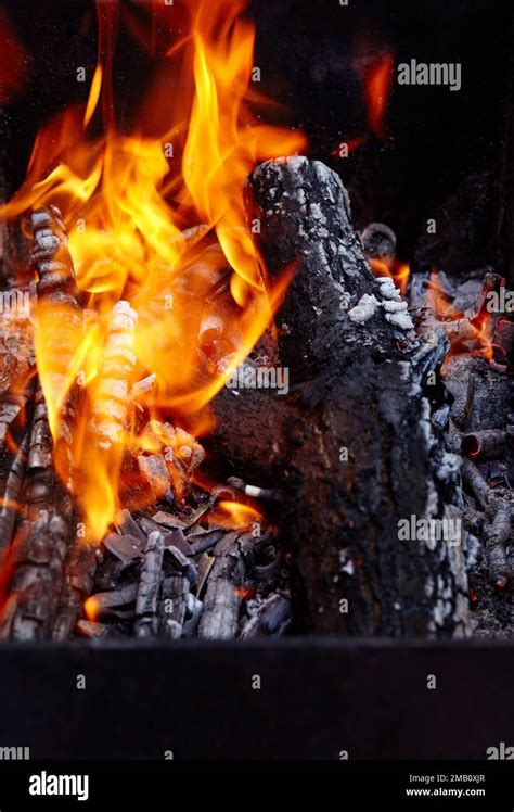 Burning Red Hot Sparks Fly From Fire Barbecue Gril With Glowing And Flaming Hot Charcoal And