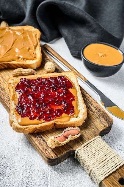 Premium Photo Peanut Butter And Jelly On White Bread Toasts