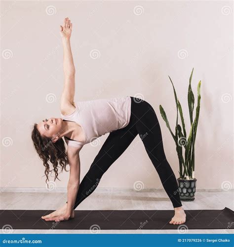 Attractive Woman Is Engaged In Yoga Performs The Exercise Utthita