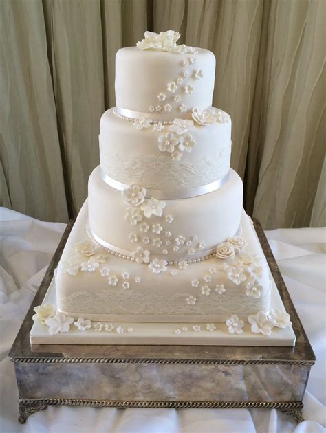 4 Tier Ivory Wedding Cake With A Lace And Blossom Detail Ivory