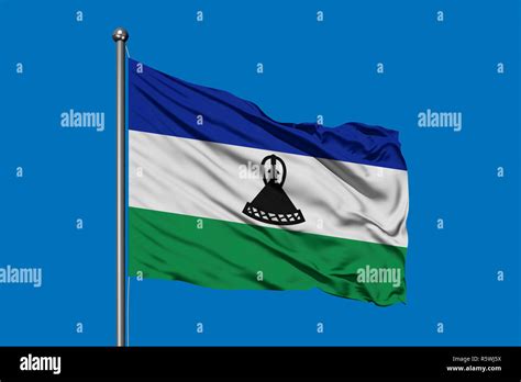 Flag Of Lesotho Waving In The Wind Against Deep Blue Sky Kingdom Of