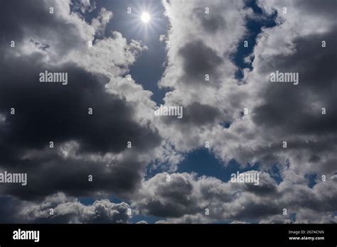 The sun shows up between the clouds hi-res stock photography and images ...