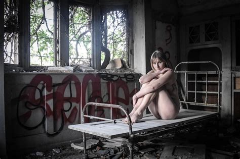 Premium Photo Full Length Of Naked Woman Sitting On Bed In Abandoned Room