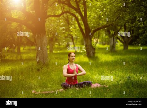 Woman sitting in yoga asana with crossed legs Stock Photo - Alamy