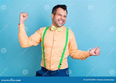 Photo Of Funny Brunet Man Hands Fists Wear Peach Shirt Isolated On Blue