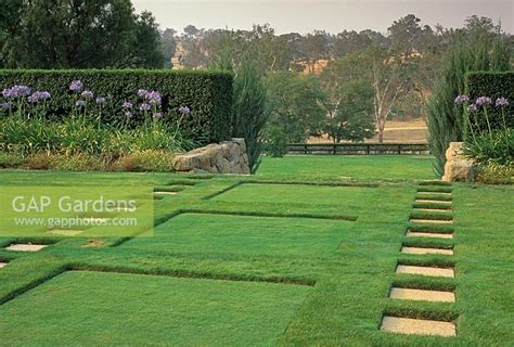 Gap Gardens Paving Slabs In Lawn Leading To Gap In Hedge And View Beyond Sunken Squares In