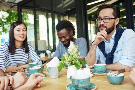 Young People Drinking Coffee At Coffeeshop Outdoors Stock Photo