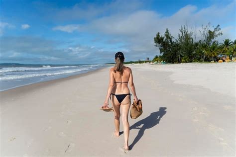 Premium Photo Woman In Bikini Walking On Beach Sand Against Blue Sky