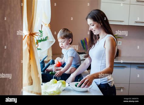 Kitchen Mom Son Wash Fruits And Vegetables Stock Photo Alamy