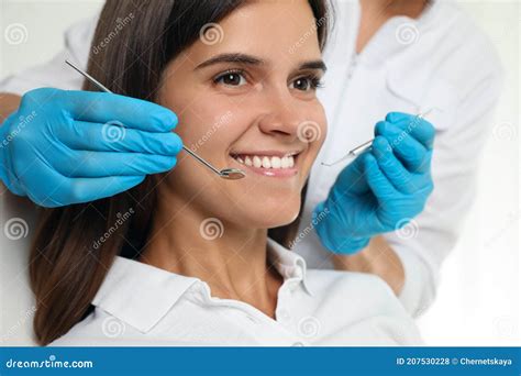 Dentist Examining Patient`s Teeth In Modern Clinic Closeup Cosmetic