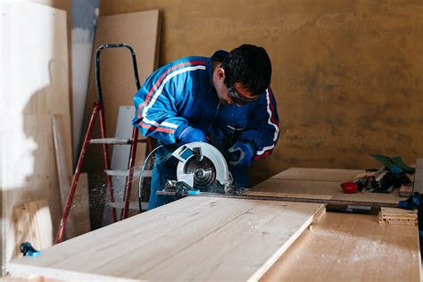 Carpenter Working With Circular Saw By Stocksy Contributor Guille