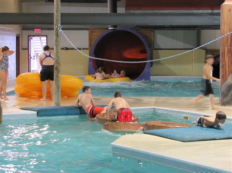 People Are Relaxing In The Water At An Indoor Swimming Pool While