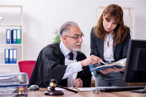 Old Male Judge And His Young Secretary In The Office Stock Image