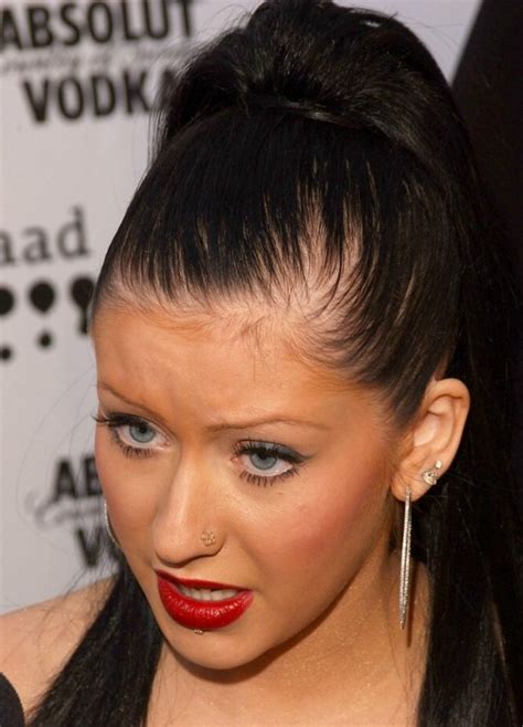Christina Aguilera's long black hair styled into a high and tight ponytail