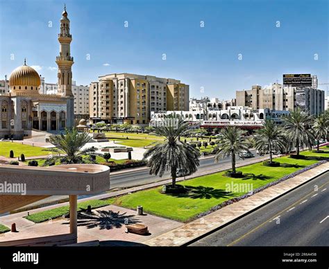 Sultan Qaboos Street Mosque Minaret Houses Palm Trees Green Cars