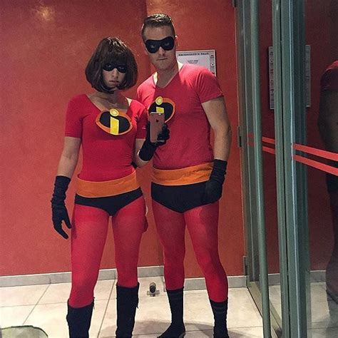 Two People In Costumes Standing Next To Each Other