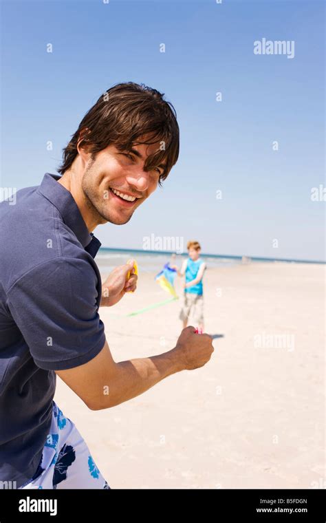 Germany Baltic Sea Father With Son 8 9 Flying Kite On Beach Stock