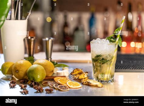 Mojito Cocktail On Bar Counter With Lemons Limes And Species With Copy