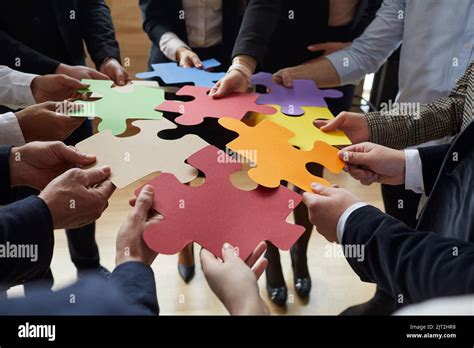 Business Team Connecting Jigsaw Puzzle And Trying To Find Creative