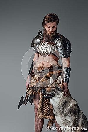 Legendary Viking With Muscular And Naked Body Posing With His Wolf