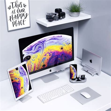 An Apple Desktop Computer Sitting On Top Of A White Desk Next To A