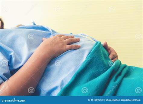 Pregnant Woman Lying On The Bed Waiting To Give Birth In A Hospital