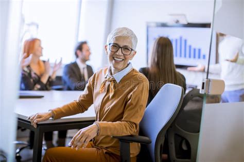 Portrait Of Cheerful Senior Businesswoman In Office Stock Image Image