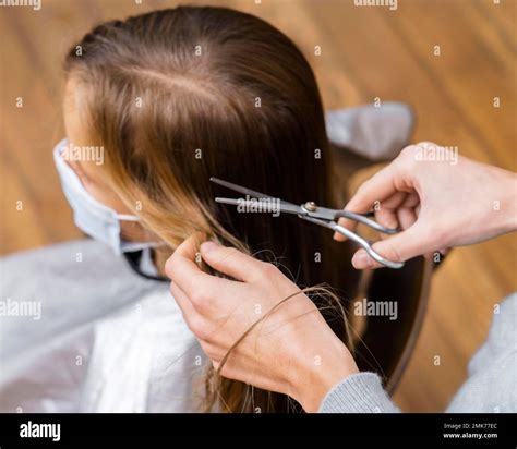 High Angle Little Girl Getting Haircut While Wearing Medical Mask High