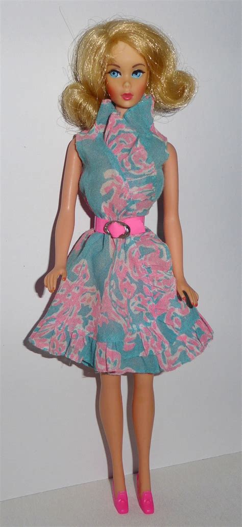 A Barbie Doll Wearing A Dress And Pink Shoes