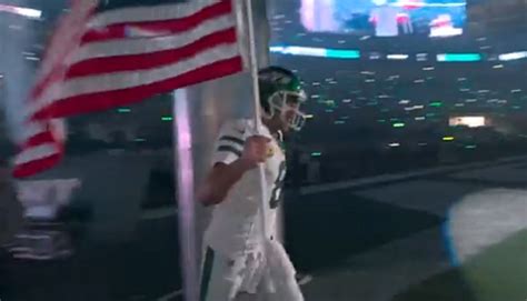 Aaron Rodgers Runs Out With American Flag On While Thunderstuck