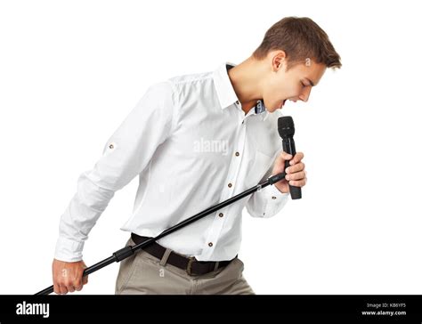 Young Man Singing Into A Microphone Isolated On White Background Stock