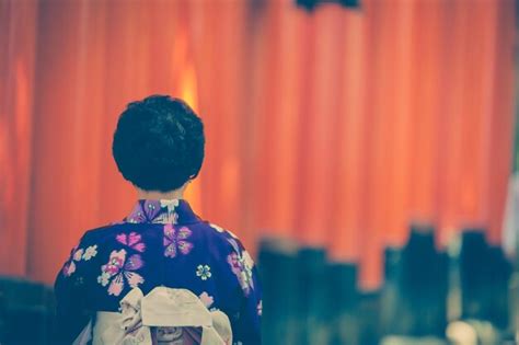 Premium Photo Rear View Of Woman Standing Against Torii Gates At