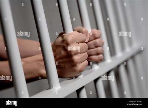 Hands On Prison Bars Stock Photo Alamy