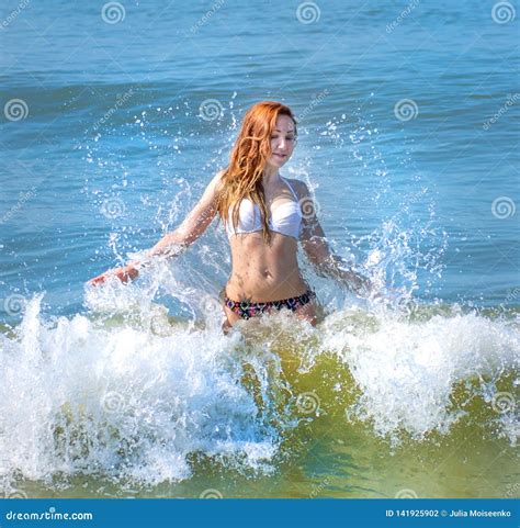 Beautiful Girl In Bikini Posing On A Deserted Beach White Sand